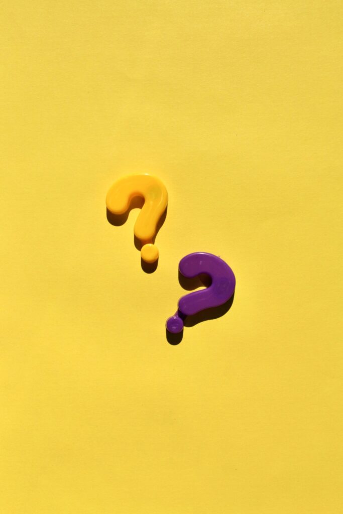 Yellow and Purple Question Marks, on a Yellow Background